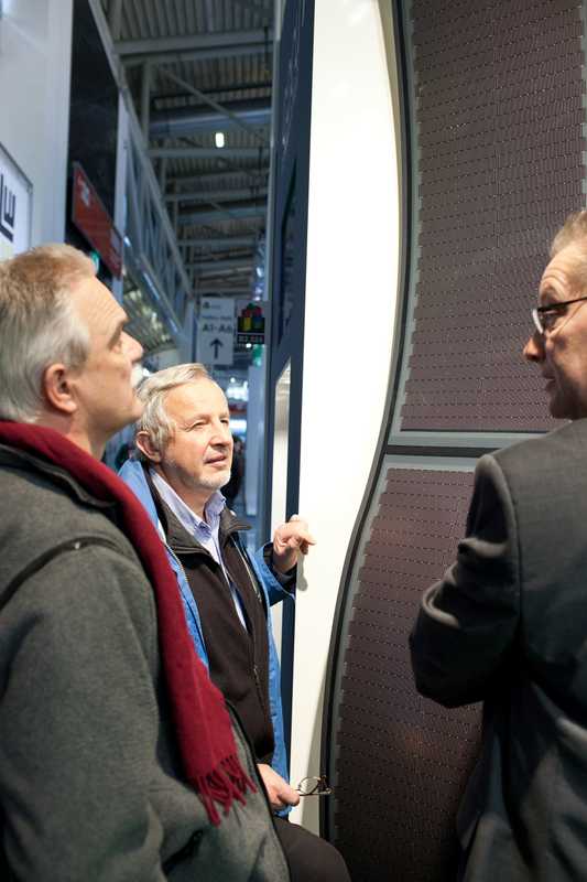 Architects examine photovoltaic panels at Boehme Systems stand 