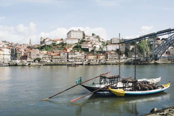 View of Porto from the south side of the River Douro, with rabelo boats in the foreground