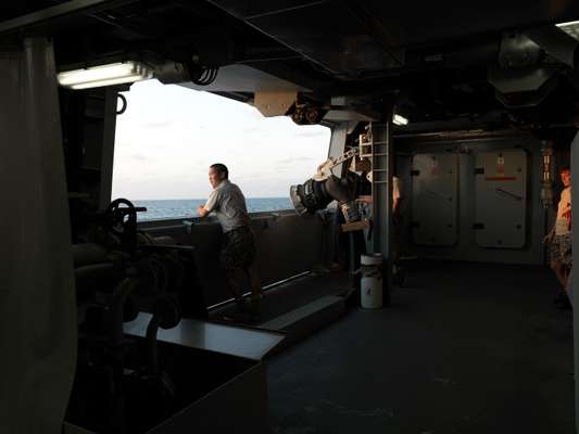 A crew member looks out to sea
