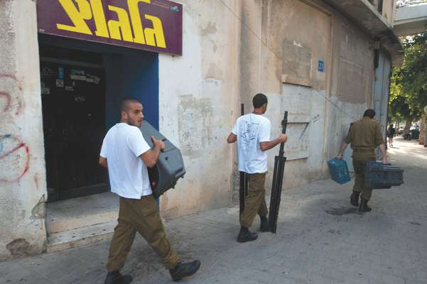 Israeli soldiers carrying audio equipment outside Galgalatz