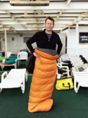 A passenger models his sleeping bag