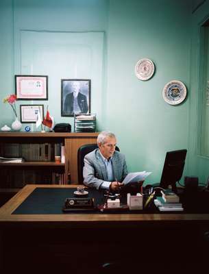 Public servant Nedim Saridag in his notary office with a photograph of Ataturk