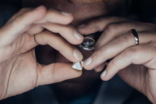 Specialist examining a 12-carat diamond to check how clean it is