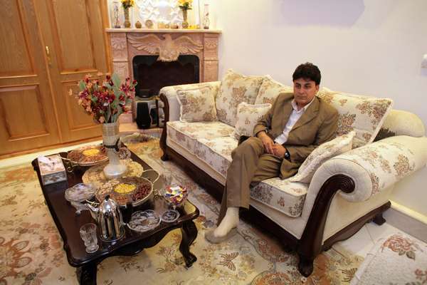 Faqiry, a legitimate local businessman, relaxes in his sitting room