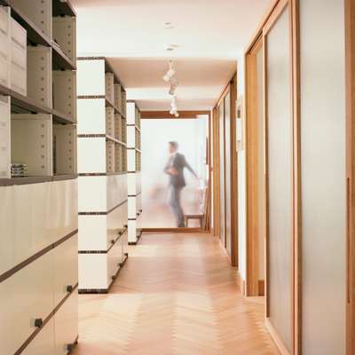 The third floor has oak parquet flooring by Bauwerk, Novex shelving and Blumer Schreinerei sliding doors separating the corridor from meeting rooms