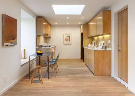 White-oak cabinets are treated simply; throughout to let light into the compact spaces