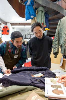 Shop staff learning about vintage aviation jackets