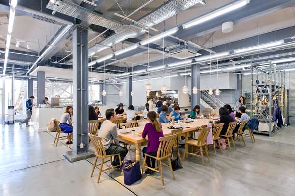 Customers share long wooden tables