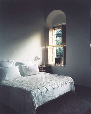 Bedrooms mix modern decor with traditional pieces such as crocheted bedspread