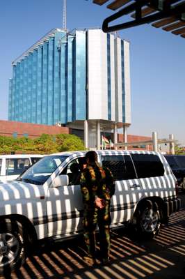 Security men and SUVs outside the International Hotel