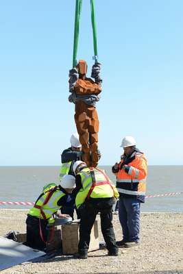 Teamwork to lift the sculpture