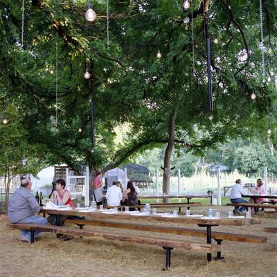 Guests arrive for dinner at the open-air restaurant, Eden East