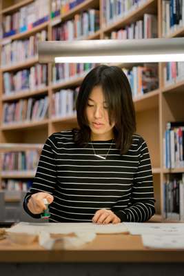 Japanese Tomomi Maezawa stamps her name onto a bag 