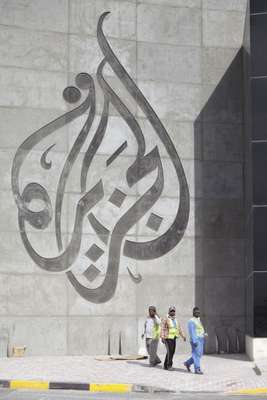 Migrant workers outside a new Al Jazeera building