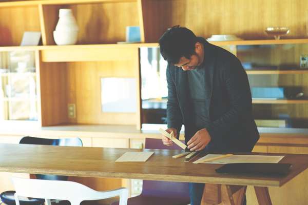 Yanagihara at work in his upstairs wooden-walled office space