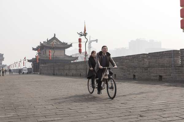 Tourists and locals ride bikes around Xi’an’s ancient city wall