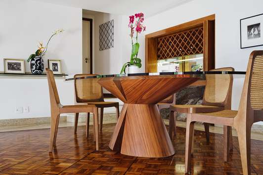 Dining area: Dinner table and chairs by Way Design with the original hardwood, marble and mirrored wine rack and drinks cabinet built into the stone behind