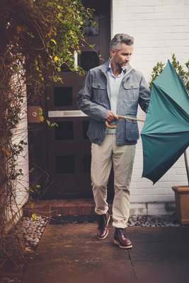 Jacket by Woolrich John Rich & Bros, jumper by Maison Kitsuné, shirt by Hackett, trousers by Incotex from Trunk, boots by Oliver Spencer, umbrella by London Undercover from Trunk