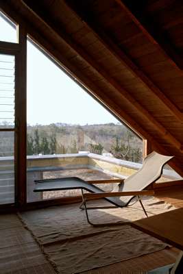 Third-sloor workspace: The workspace has stunning views to the sea. Folding chaise by Takeshi Nii. Ito specialises in design and architecture photography and co-authored *Mod East*, a record of Japanese architecture of the 1950s, 1960s and 1970s. 