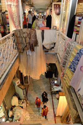 People browsing a curtain fabrics market 