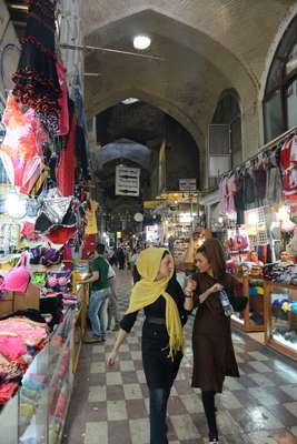 Two women walk past colourful underwear in the Grand Bazaar