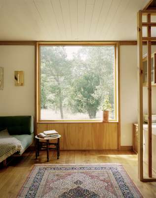 Square window at one end of the living room