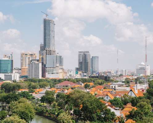 High-rise construction sites provide a backdrop to Dutch colonial buildings in central Surabaya