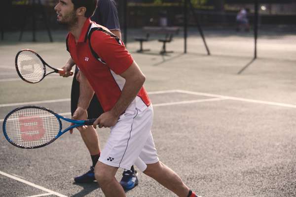 polo shirt, shorts both by Yonex, racquet by Wilson cap, t-shirt, racquet all by Prince, ball by Wilson