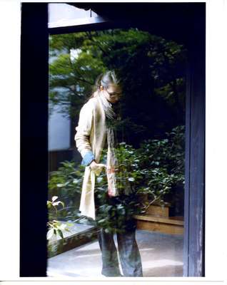 Cardigan by Ralph Lauren Blue Label, shirt by Rem Relief from L’Apartement, scarf by Burberry, trousers by Drawer, glasses by 
Bottega Veneta