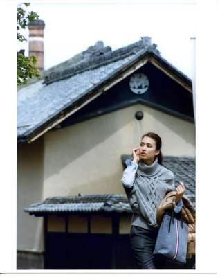 Poncho by Gucci, shirt by Beams, trousers and bag by Black Fleece By Brooks Brothers, jacket (carried) by Moncler