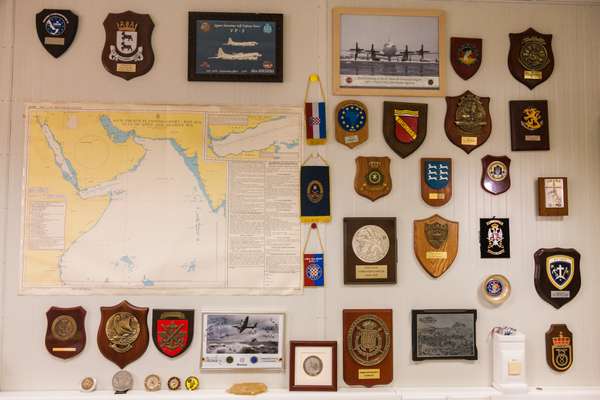 Squadron and regimental badges adorn a wall in the office of the EU mission commander 