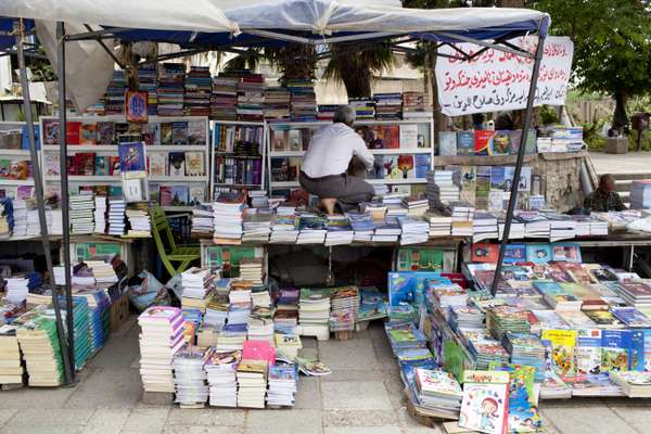 Bookseller arranging his stall in the bazaar