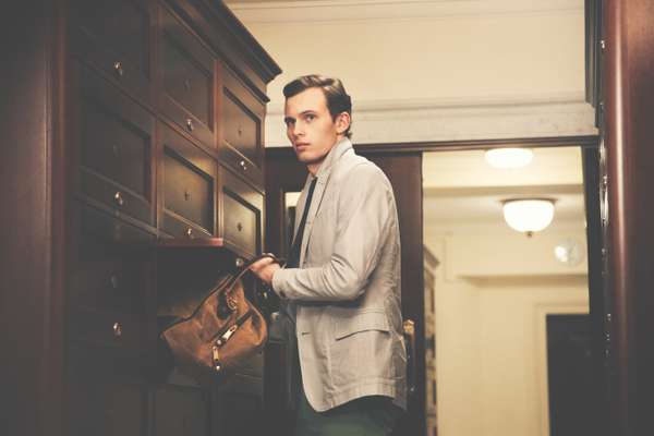 Chay wears jacket by Oliver Spencer, shirt and trousers by Hackett, tie by TS(S), bag by Woolrich John Rich & Bros