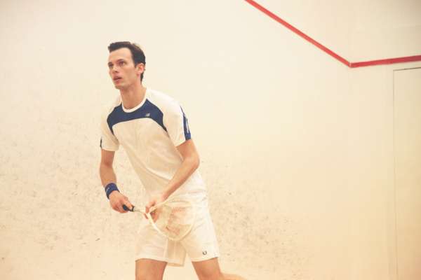  Ben wears red t-shirt by New Balance, shorts by Lotto, wristband and shoes by Nike, racquet by Wilson