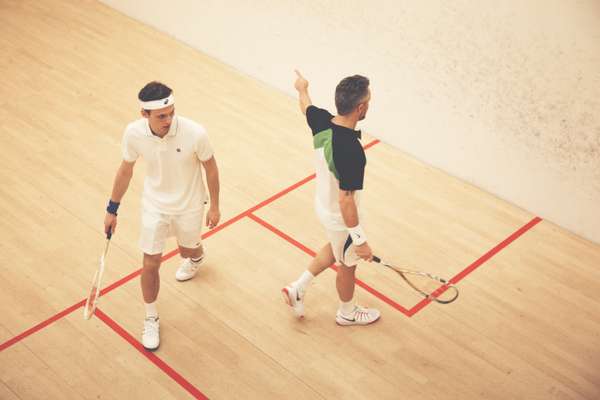 Ben wears black, green and white t-shirt by Dunlop, shorts by Lotto, wristband and shoes by Nike, racquet by Wilson, drinks bottle by Asics