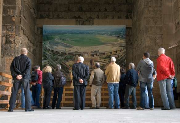 Tourists admire a photo of the airport inside Tempelhof’s hall