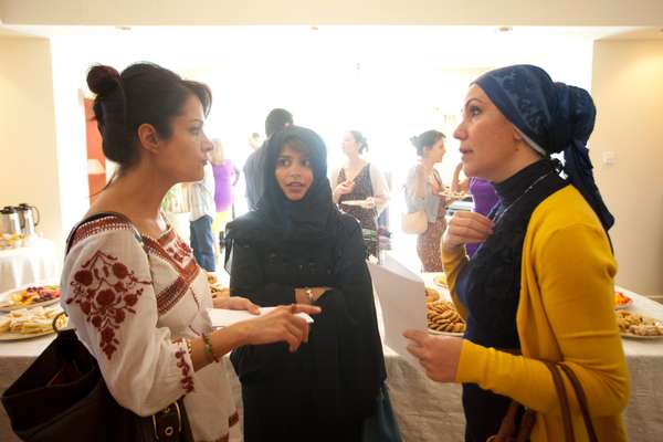 Three guests chat at the party