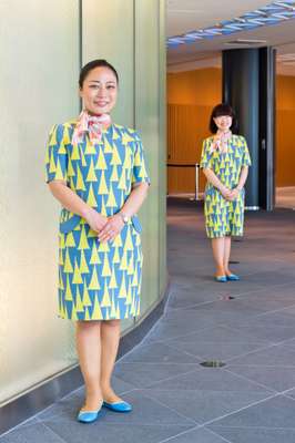 Guides wear dresses designed by Akira Minagawa, featuring the tower motif