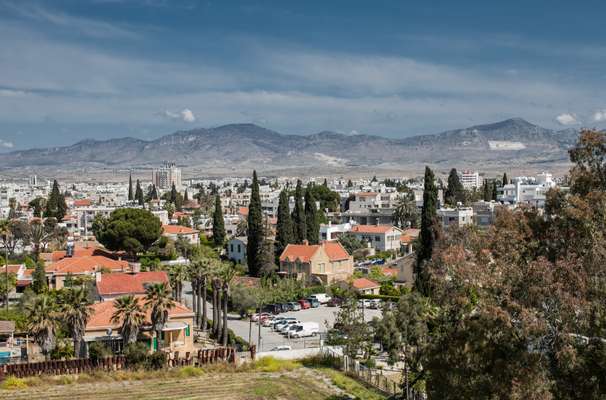 View from Ledra Palace Hotel over both Greek and Turkish Nicosia with the Turkish Republic of Northern Cyprus flag visible painted on a mountain