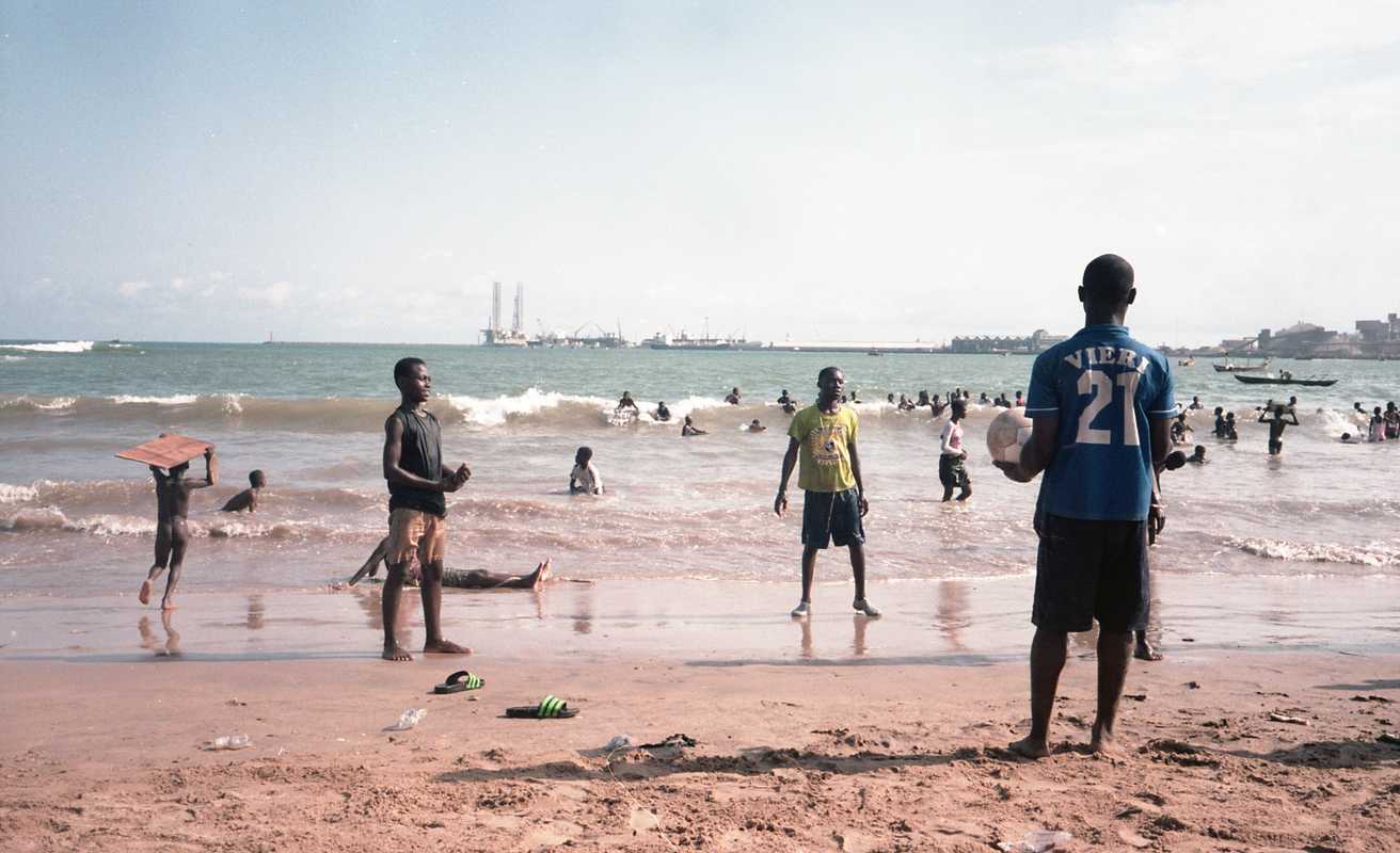 Kids playing football at a beach in Takoradi 