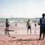 Kids playing football at a beach in Takoradi 