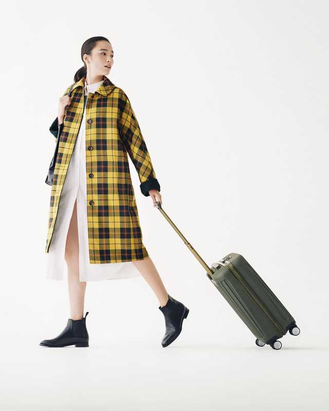 Coat by Mackintosh, dress by Priory, boots by Church’s, bag by Smythson, suitcase by Piquadro