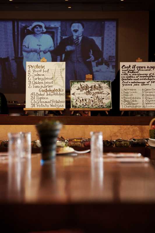 The central table with a still from a Charlie Chaplin film beamed onto the wall behind the create-your-own menus
