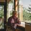 Canadian architect Ian MacDonald in his cabin home on the shore