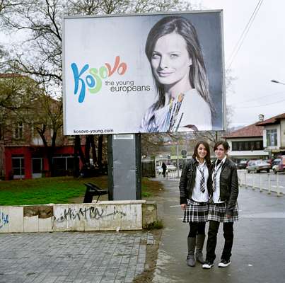 Teenagers in front of an ad, part of a state-funded campaign created by Saatchi & Saatchi