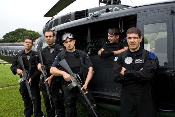 Police officers from the elite tactical unit, prepare to board the UH-1H helicopter