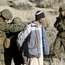 An Afghan ‘villager’ is searched by Marines and ANA role players