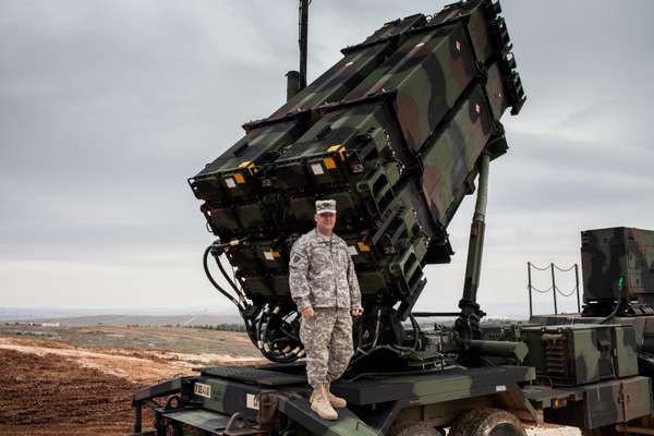 Colonel John Wanat stands in front of a PAC-3 launcher