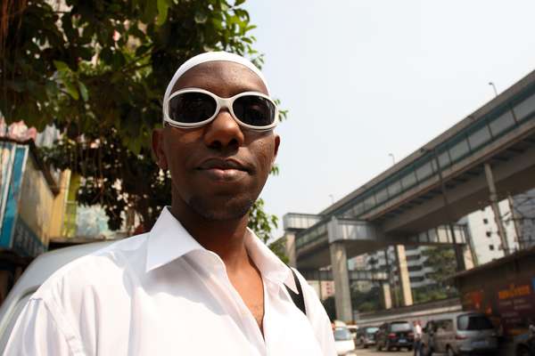 A Somalian man waits for a taxi to Friday prayers