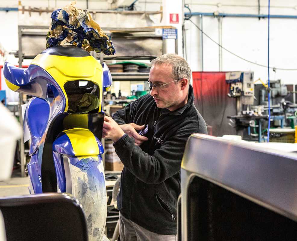 An employee inspects a MotoCoaster seat